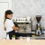 a barista brewing coffee