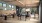 a group of people sitting at a table in a room with a wood floor