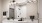 a bathroom with white cabinets and large mirror