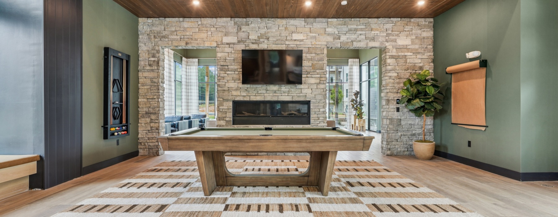 Modern Game Room with Pool Table and Stone Fireplace